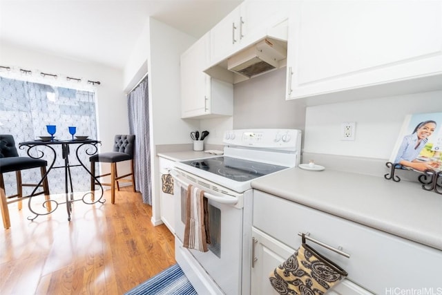 kitchen featuring white cabinets, light countertops, white range with electric cooktop, and under cabinet range hood