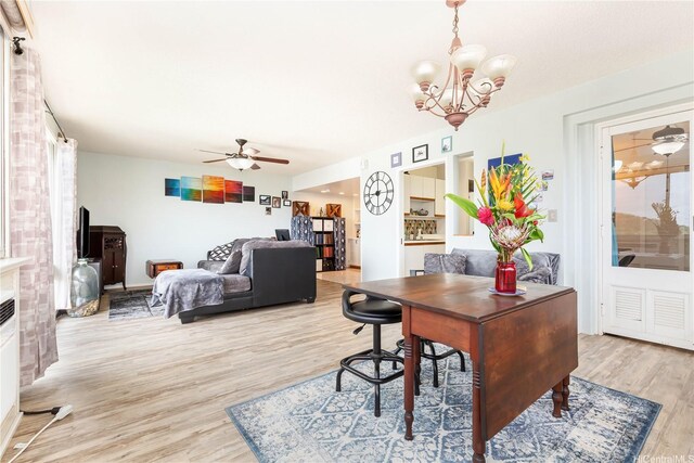 1022 Prospect St Unit 704A, Honolulu, HI 96822 - dining space featuring light wood-style floors, a chandelier, a ceiling fan, and healthy amount of natural light