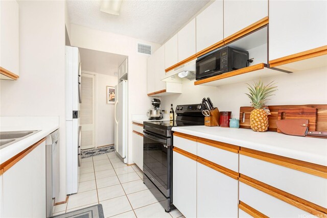 1022 Prospect St Unit 704A, Honolulu, HI 96822 - kitchen featuring black appliances, white cabinets, light countertops, and under cabinet range hood