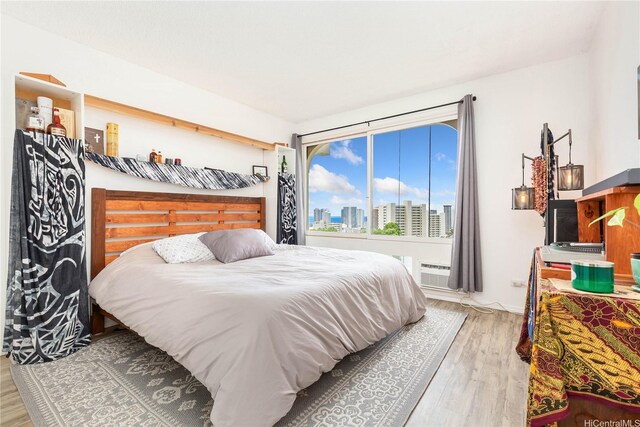 1022 Prospect St Unit 704A, Honolulu, HI 96822 - bedroom with a view of skyline and wood finished floors