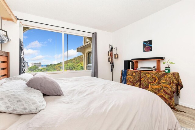 1022 Prospect St Unit 704A, Honolulu, HI 96822 - bedroom with wood finished floors and baseboards