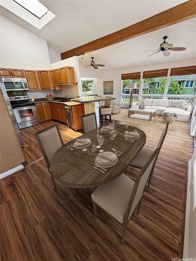 44-313 Kaneohe Bay Dr Unit B, Kaneohe, HI 96744 - dining room with a skylight, wood finished floors, beam ceiling, and ceiling fan