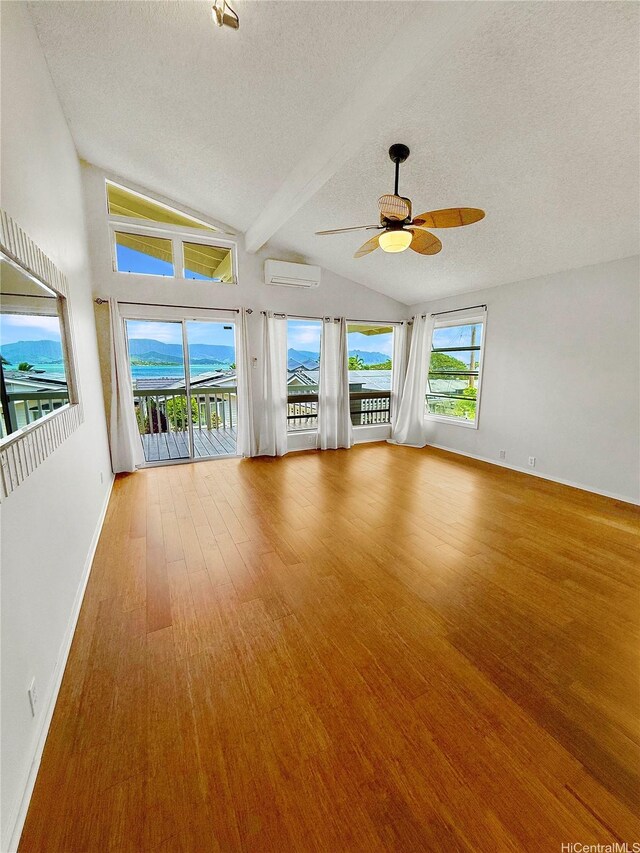 44-313 Kaneohe Bay Dr Unit B, Kaneohe, HI 96744 - unfurnished room with an AC wall unit, a textured ceiling, a ceiling fan, wood finished floors, and baseboards