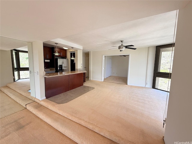 521 Hahaione St Unit 2-15L, Honolulu, HI 96825 - kitchen featuring stainless steel refrigerator with ice dispenser, light carpet, open floor plan, and ceiling fan