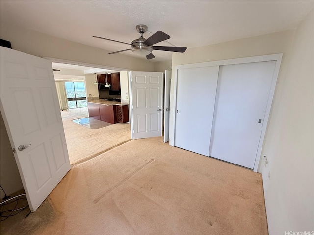 521 Hahaione St Unit 2-15L, Honolulu, HI 96825 - unfurnished bedroom with light colored carpet, a closet, and a ceiling fan