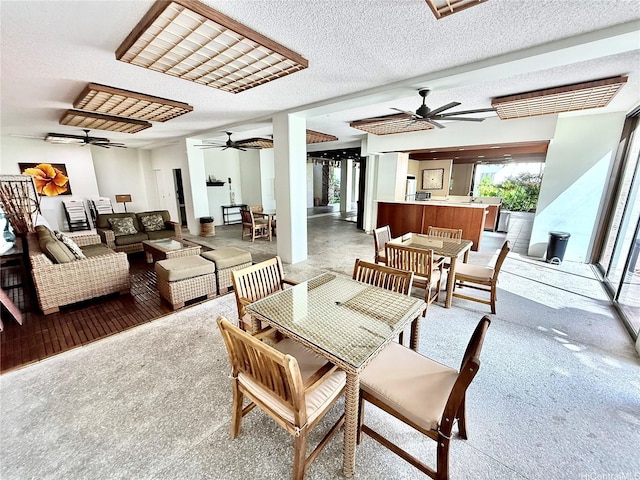 521 Hahaione St Unit 2-15L, Honolulu, HI 96825 - dining space with ceiling fan, light carpet, and a textured ceiling