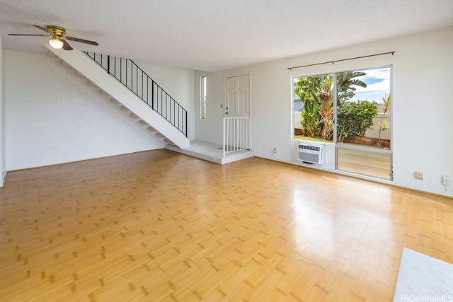 94-1199 Meleinoa Pl Unit 21C, Waipahu, HI 96797 - unfurnished living room featuring stairway, a textured ceiling, a ceiling fan, and wood finished floors