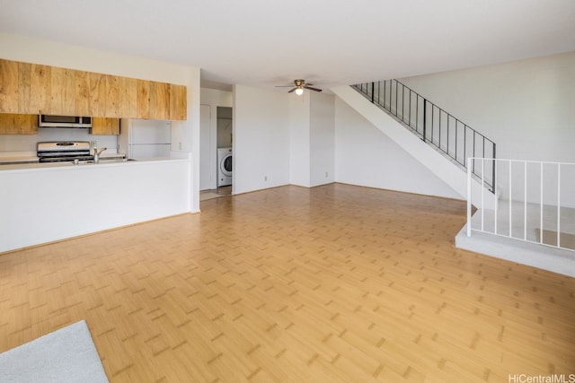 94-1199 Meleinoa Pl Unit 21C, Waipahu, HI 96797 - unfurnished living room featuring light wood-style floors, stairs, washer / clothes dryer, and ceiling fan