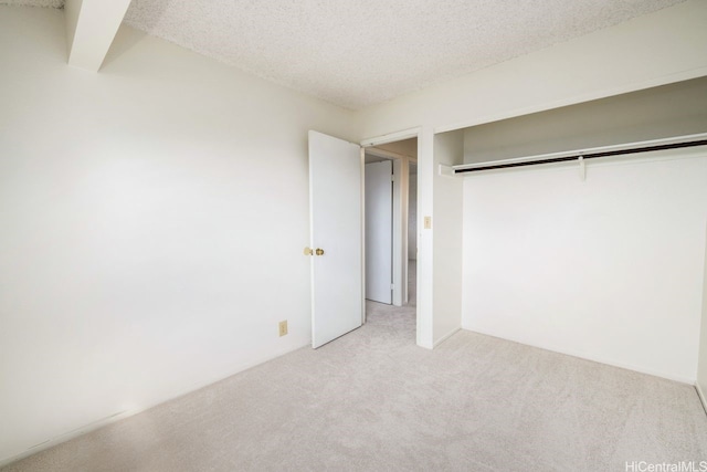 94-1199 Meleinoa Pl Unit 21C, Waipahu, HI 96797 - unfurnished bedroom featuring carpet flooring, a textured ceiling, and a closet