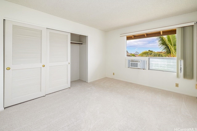 94-1199 Meleinoa Pl Unit 21C, Waipahu, HI 96797 - unfurnished bedroom featuring a textured ceiling, baseboards, cooling unit, a closet, and carpet