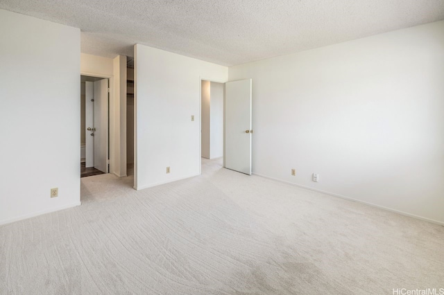 94-1199 Meleinoa Pl Unit 21C, Waipahu, HI 96797 - empty room with baseboards, a textured ceiling, and light carpet