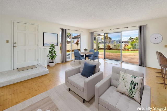 94-1199 Meleinoa Pl Unit 21C, Waipahu, HI 96797 - living room with a textured ceiling and wood finished floors