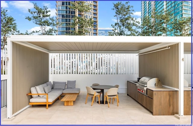 view of patio / terrace featuring exterior kitchen, grilling area, and outdoor dining space