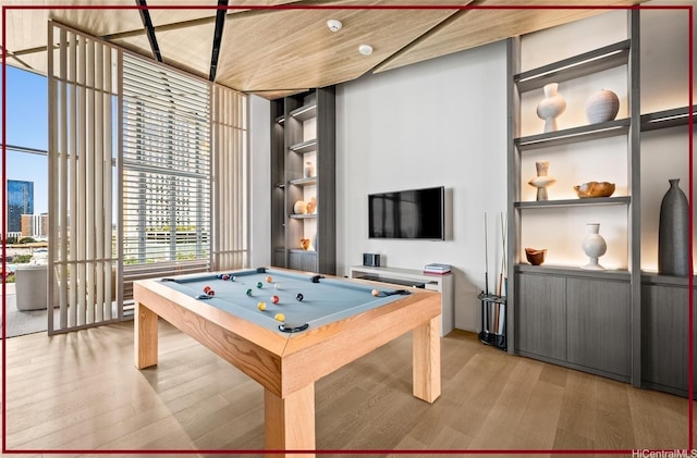 recreation room featuring a wall of windows, pool table, light wood-style floors, and built in shelves