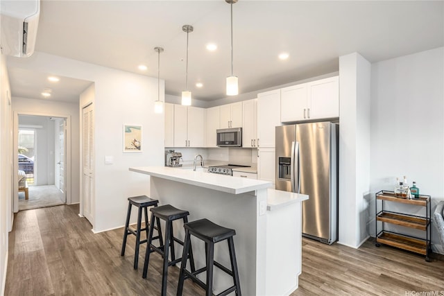 91-3525 Kauluakoko St Unit 2112, Ewa Beach, HI 96706 - kitchen featuring stainless steel appliances, dark wood-type flooring, light countertops, an island with sink, and recessed lighting