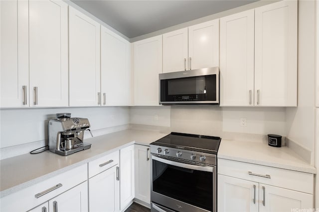 91-3525 Kauluakoko St Unit 2112, Ewa Beach, HI 96706 - kitchen with appliances with stainless steel finishes, white cabinetry, and light countertops