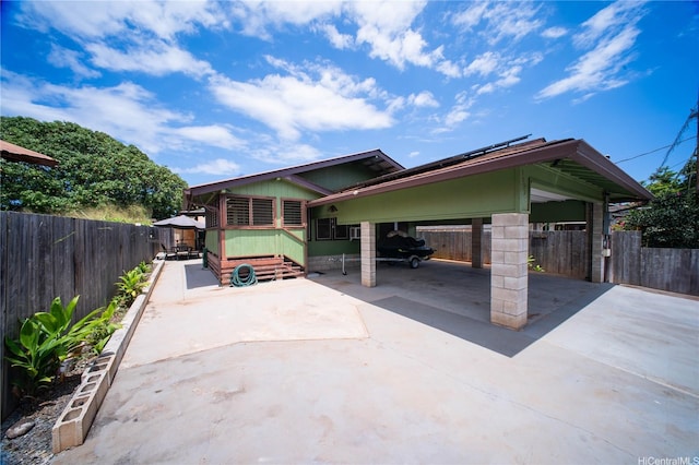 66-925 Ulihi Pl, Waialua, HI 96791 - view of patio featuring fence, concrete driveway, and an attached carport