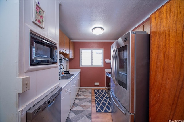 66-925 Ulihi Pl, Waialua, HI 96791 - kitchen featuring appliances with stainless steel finishes, light countertops, a sink, a textured ceiling, and baseboards
