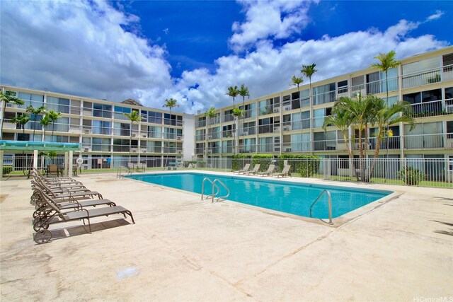 community pool featuring fence and a patio area