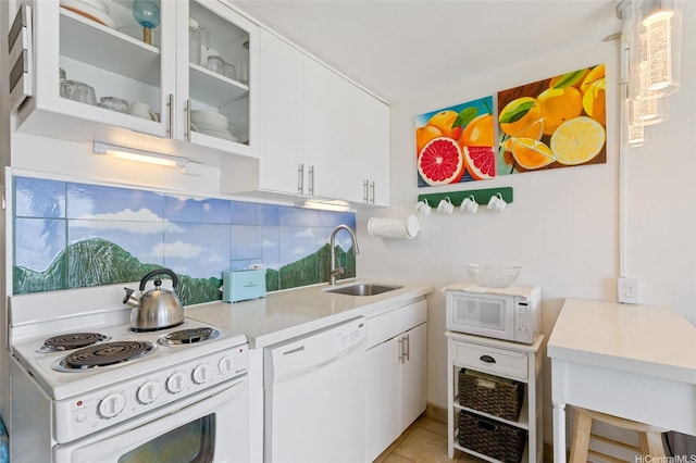 85-175 Farrington Hwy Unit A402, Waianae, HI 96792 - kitchen featuring white appliances, light countertops, white cabinets, glass insert cabinets, and light tile patterned floors