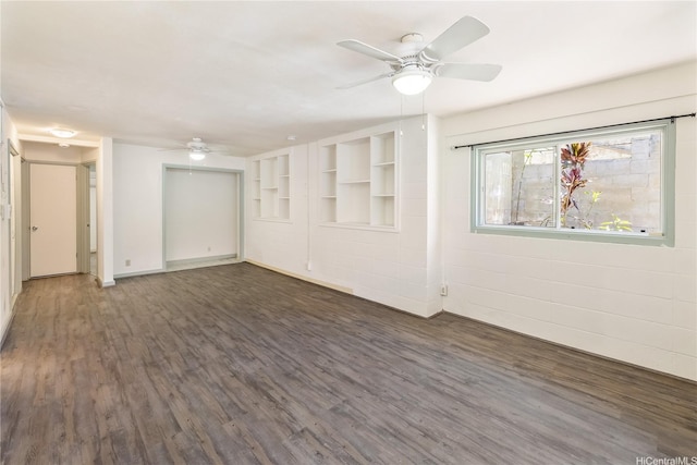 interior space with baseboards, wood finished floors, and ceiling fan
