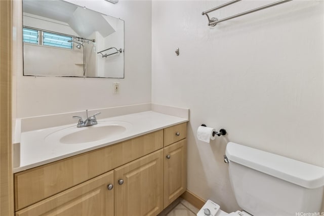 bathroom featuring toilet and vanity