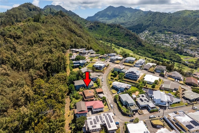 aerial view with a mountain view, a view of trees, and a residential view