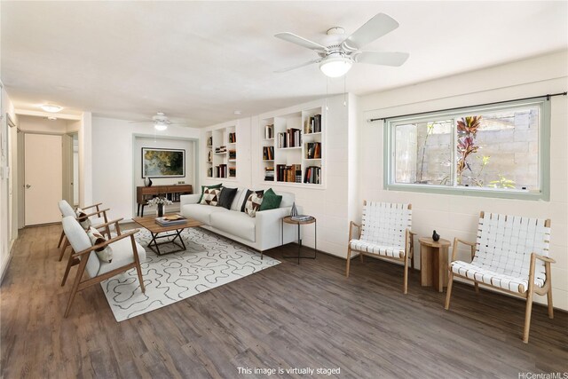living room with built in features, a ceiling fan, and wood finished floors