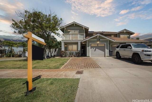 view of front of property featuring a garage, a front yard, a balcony, and concrete driveway