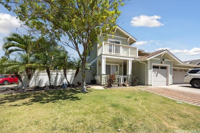 view of front facade featuring a garage, a front yard, a balcony, and fence