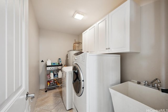 washroom with washer / clothes dryer, a sink, cabinet space, and water heater
