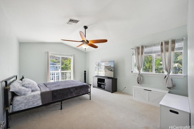 bedroom with light carpet, visible vents, vaulted ceiling, and ceiling fan