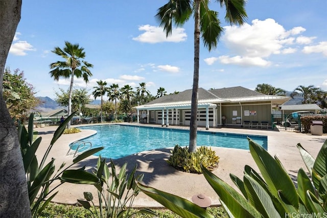 pool with a patio and fence