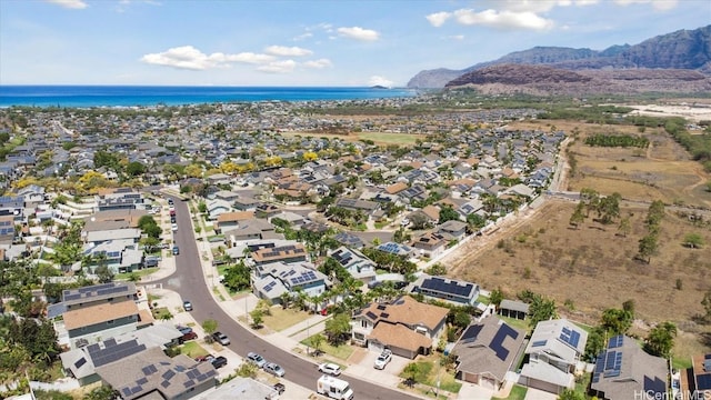 drone / aerial view featuring a residential view and a water view