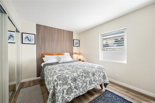 222 Kaiulani Ave Unit 208, Honolulu, HI 96815 - bedroom featuring baseboards and wood finished floors