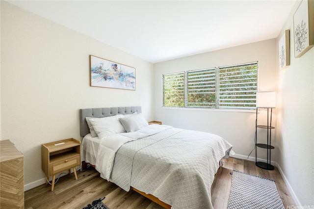 222 Kaiulani Ave Unit 208, Honolulu, HI 96815 - bedroom with baseboards and wood finished floors
