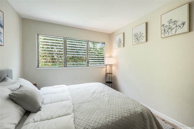 222 Kaiulani Ave Unit 208, Honolulu, HI 96815 - bedroom with baseboards, multiple windows, and wood finished floors