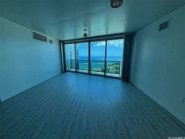 1177 Queen St Unit 3905, Honolulu, HI 96814 - unfurnished room with wood finished floors, baseboards, and floor to ceiling windows