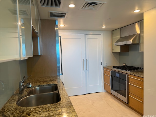 1177 Queen St Unit 3905, Honolulu, HI 96814 - kitchen with wall oven, wall chimney range hood, a sink, light tile patterned flooring, and stainless steel gas stovetop