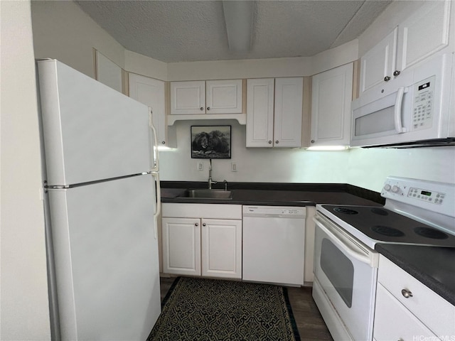 430 Keoniana St Unit 112, Honolulu, HI 96815 - kitchen with white appliances, dark countertops, white cabinetry, a sink, and a textured ceiling