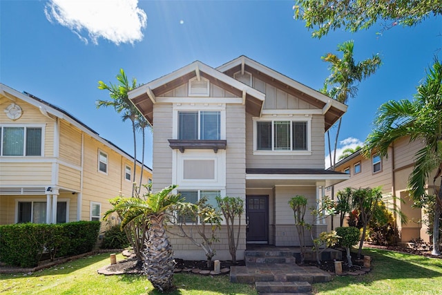 91-1092 Kaileolea Dr, Ewa Beach, HI 96706 - view of front of house with a front yard and board and batten siding