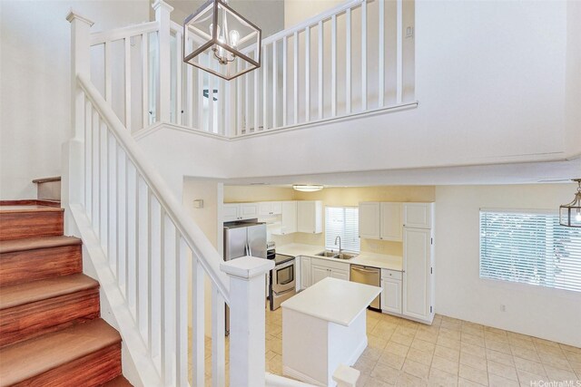 91-1092 Kaileolea Dr, Ewa Beach, HI 96706 - stairs featuring a chandelier, a towering ceiling, and tile patterned flooring