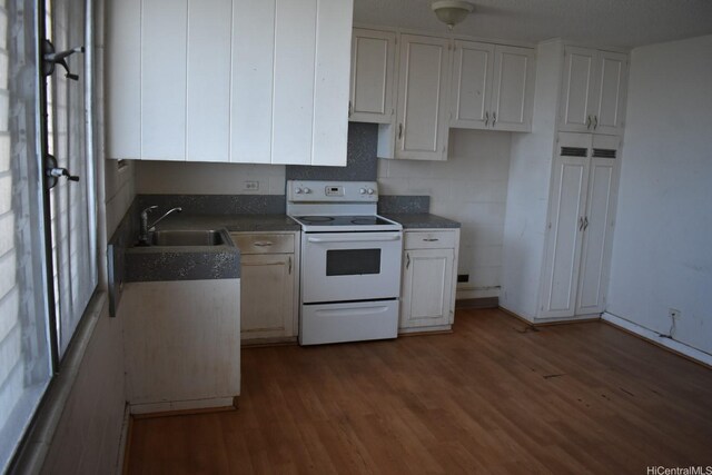 1516 Emerson St Unit 104, Honolulu, HI 96813 - kitchen with white cabinets, a sink, dark countertops, white electric range, and wood finished floors