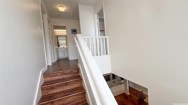 stairs with wood finished floors and baseboards