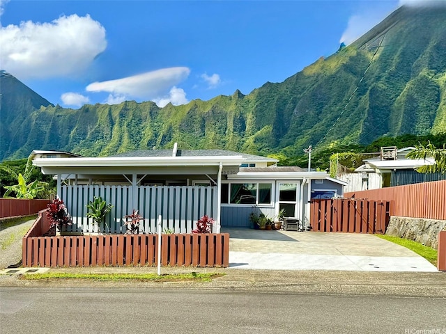 view of front facade with fence and a mountain view