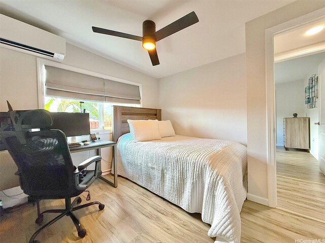 bedroom with an AC wall unit, ceiling fan, and wood finished floors