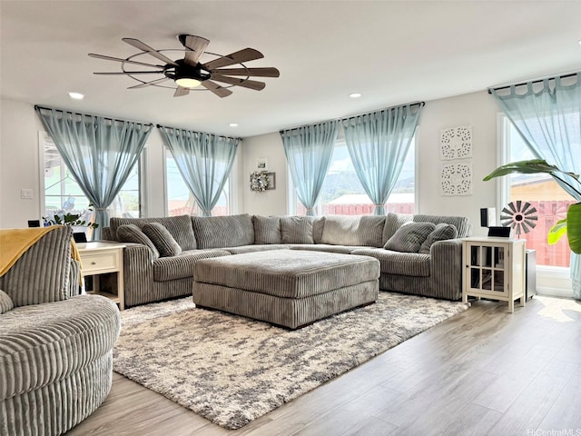 living room featuring recessed lighting, ceiling fan, wood finished floors, and a wealth of natural light