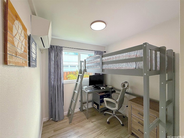bedroom with baseboards and wood finished floors