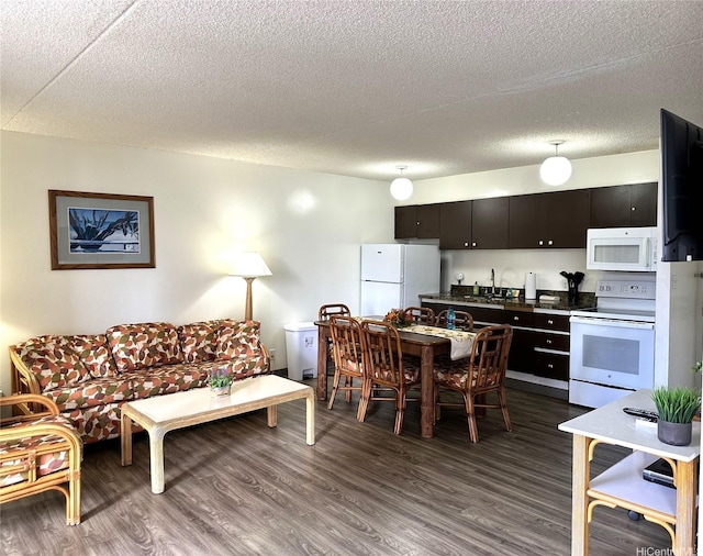 interior space with a textured ceiling and dark wood finished floors