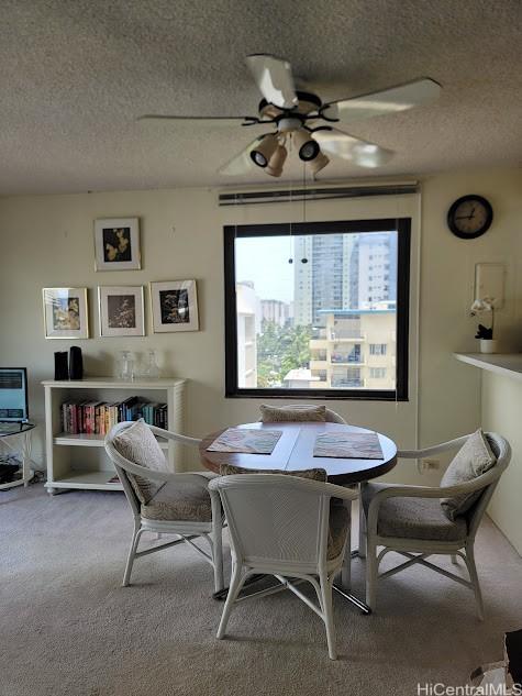 2140 Kuhio Ave Unit 801, Honolulu, HI 96815 - dining room with a textured ceiling, a ceiling fan, and carpet flooring